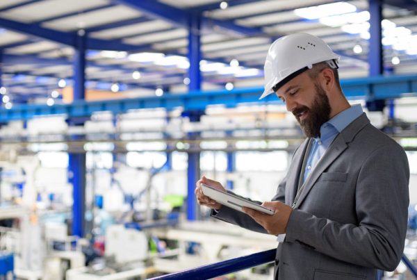 Industrial manager reviewing waste portal for multi-site manufacturing waste management