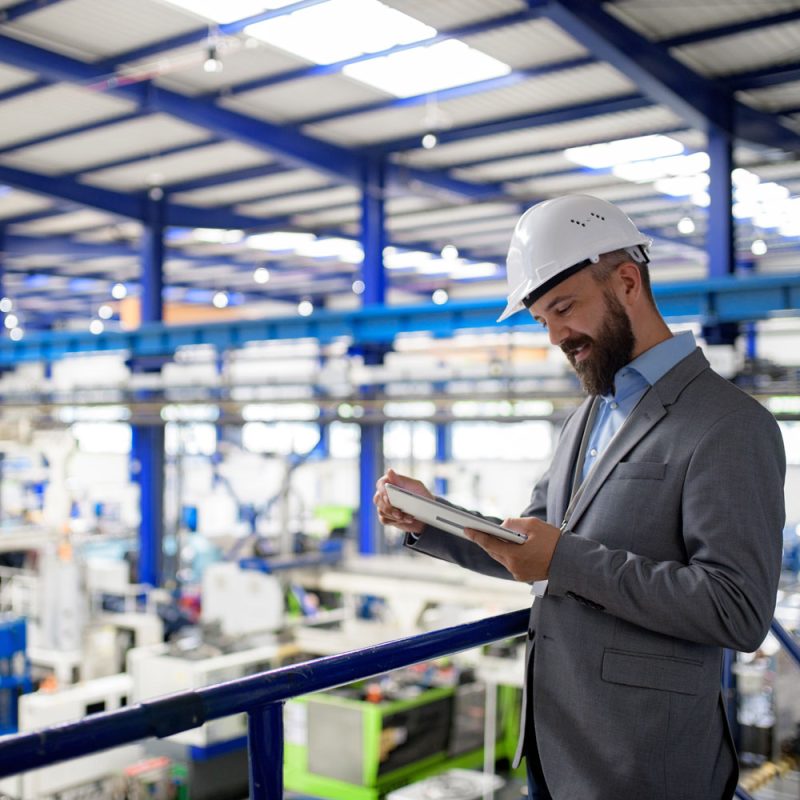 How multi-site manufacturers regain control of waste spend 1 Industrial manager reviewing waste portal for multi-site manufacturing waste management