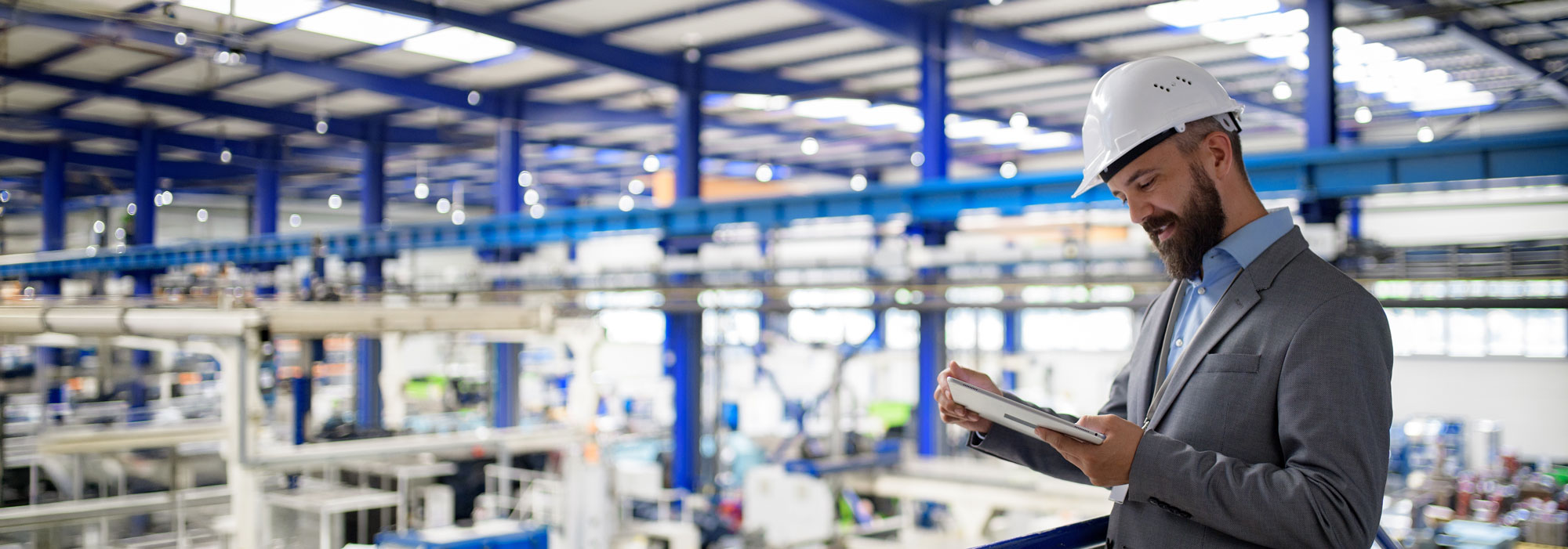 Industrial manager reviewing waste portal for multi-site manufacturing waste management