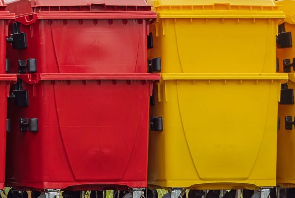 Feature: manufacturing waste segregation orderly space red yellow blue industrial bins