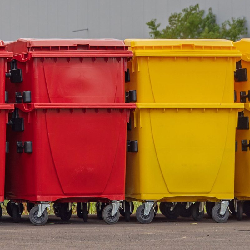 Feature: manufacturing waste segregation orderly space red yellow blue industrial bins